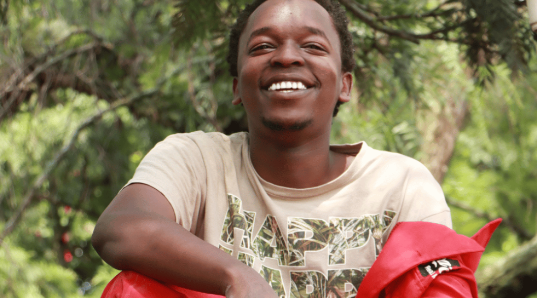 A young person smiles to camera